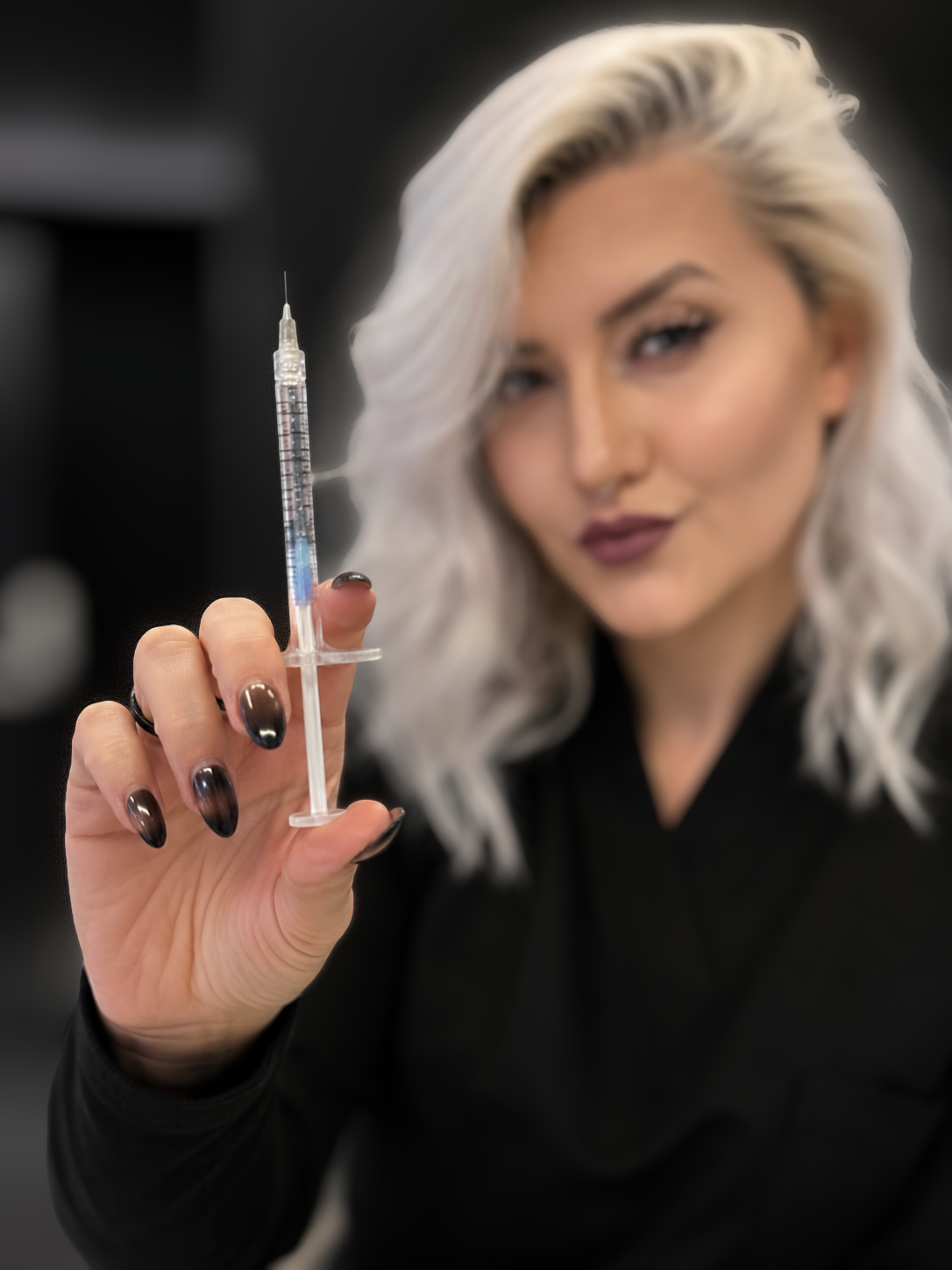 Alyssa Hoover, nurse practitioner at FRZN Aesthetics in Frisco, Texas, holding a Radiesse syringe