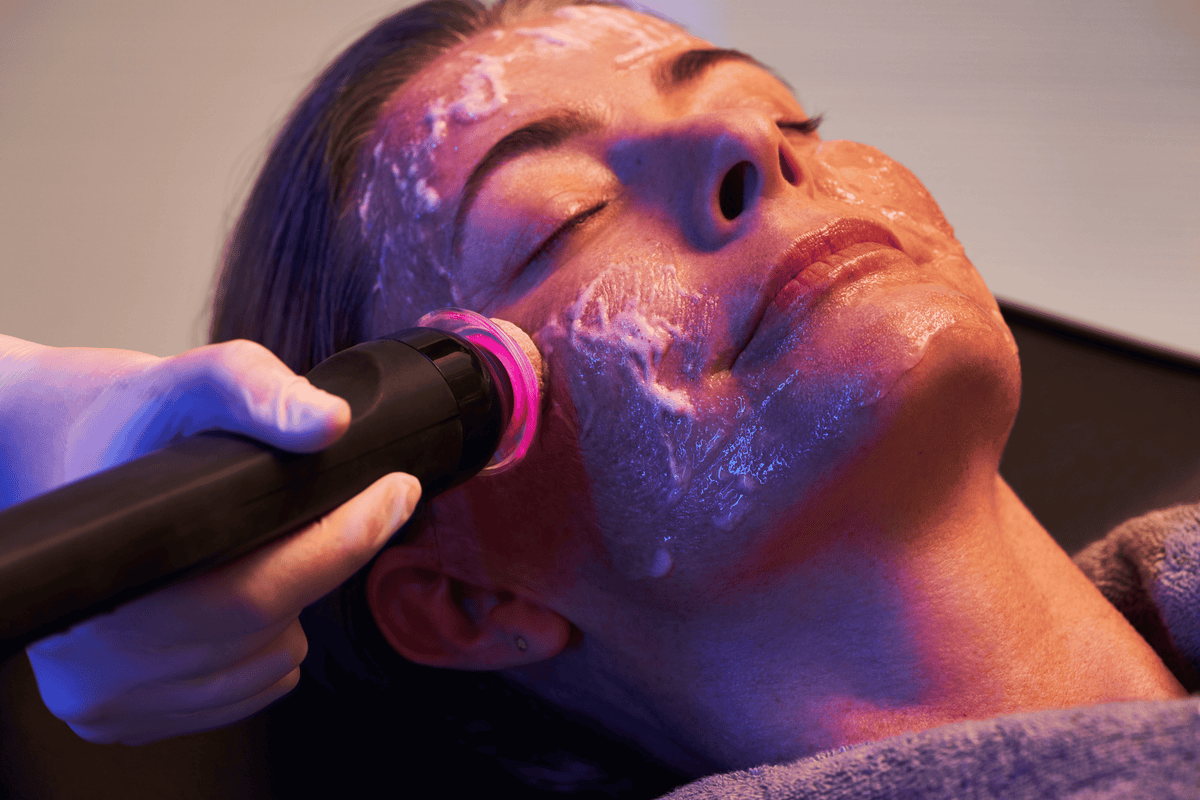Oxy2 oxygenating facial in progress with the treatment applicator gliding across gel covered skin at FRZN Aesthetics in Frisco, TX